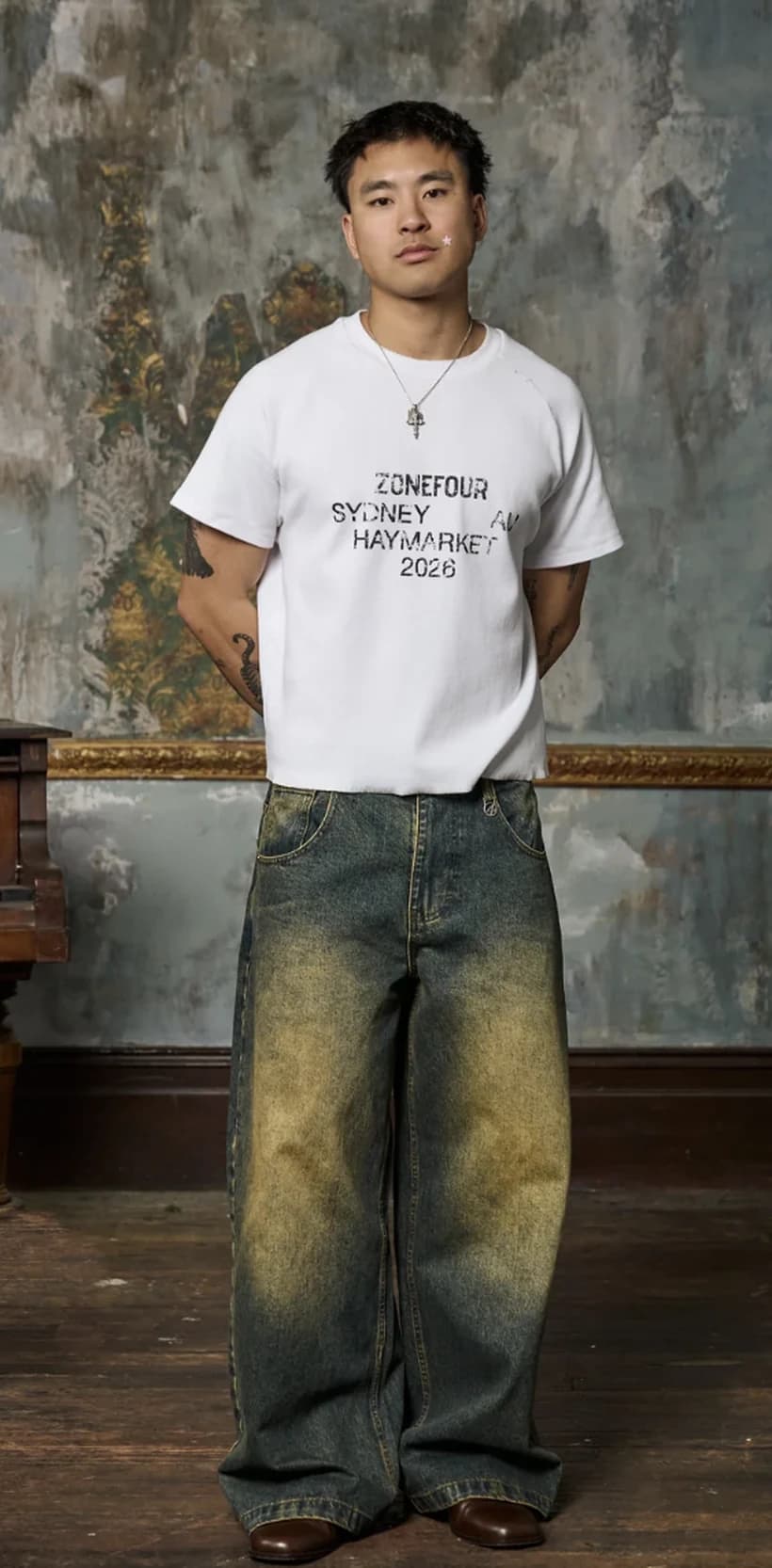 A full-length photo of a person in a plain white t-shirt and jeans